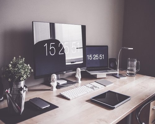 Ergonomic workspace setup with a laptop stand on a modern desk